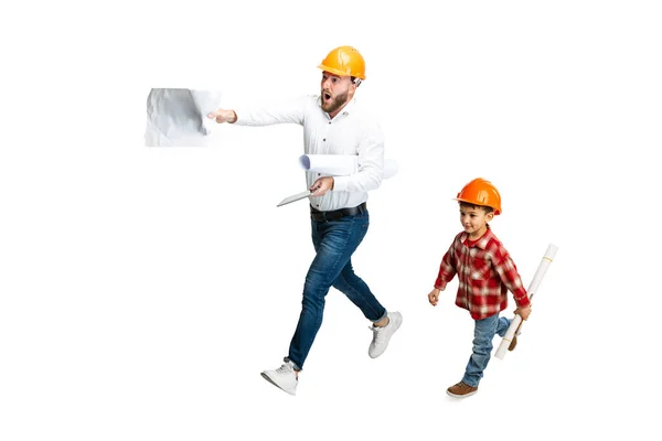 Young bearded man, builder, designer with professional equipment talking with little kid, son isolated on white background. — Stock Photo, Image