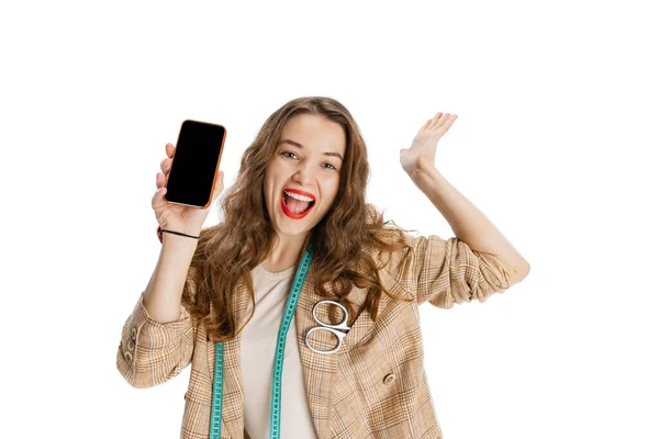 Retrato de cerca de una joven sonriente, modista usando un teléfono aislado sobre fondo blanco. Concepto de trabajo, hobby — Foto de Stock