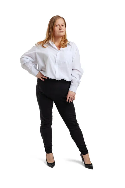 Full-length portrait of plus-size woman wearing white t-shirt and jeans posing isolated on white studio background. Body positive concept — Stock Photo, Image