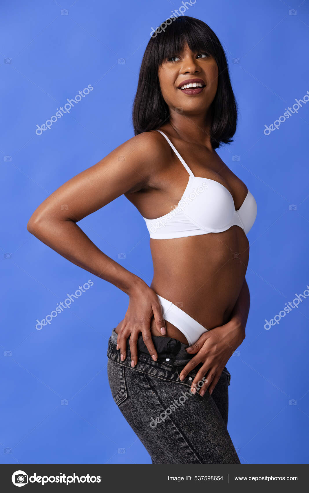 The Body Of A Young And Beautiful Woman In Female Underwear Showing Lingerie  To The Camera, Isolated On A Gray Background. Fashion Concept, Copy Space.  Stock Photo, Picture and Royalty Free Image.