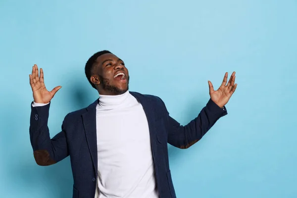 Portrait of young stylish excited man, student wearing white neck-polo and jacket isolated on navy color background. — Fotografia de Stock