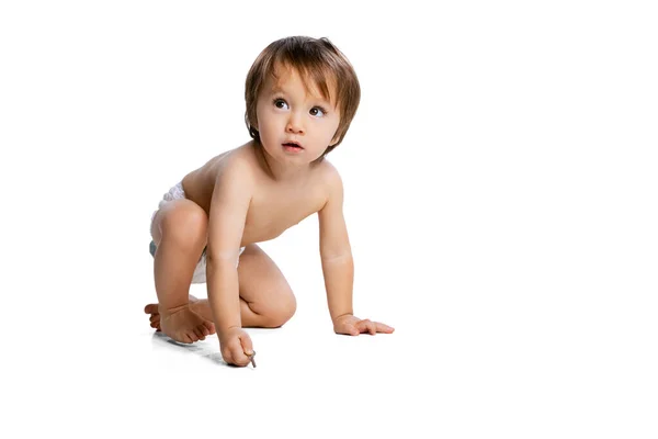 Portrait of little boy, baby, child in diaper posing isolated over white studio background. Childhood concept — Fotografia de Stock
