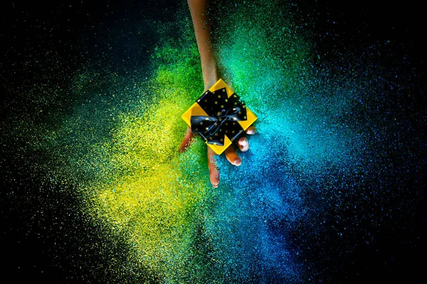 Female hand and explosion of colored, neoned powder on black studio background with copy space. Magazine cover, wallpaper design — 图库照片