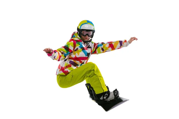 Portrait of young woman in bright sportswear, goggles and helmet snowboarding isolated on white studio background. Concept of winter sports — Fotografia de Stock