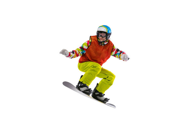 One young woman in bright sportswear, goggles and helmet snowboarding isolated on white studio background. Concept of winter sports