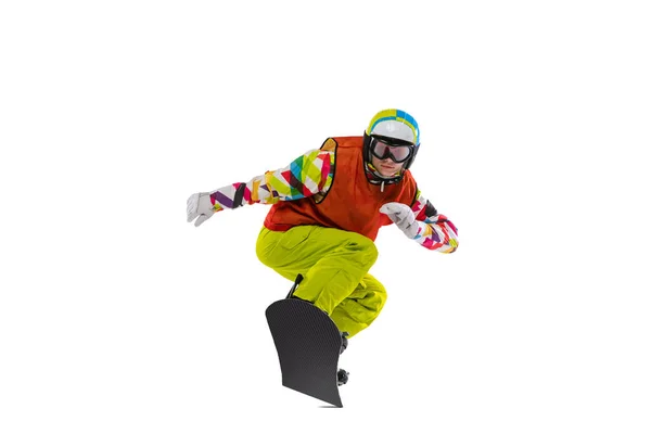 Одна молода жінка в яскравому спортивному одязі, окулярах і шоломі сноуборді ізольована на білому фоні студії. Концепція зимових видів спорту — стокове фото
