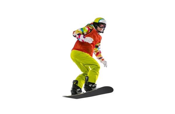 Portrait of young woman in bright sportswear, goggles and helmet snowboarding isolated on white studio background. Concept of winter sports — стоковое фото