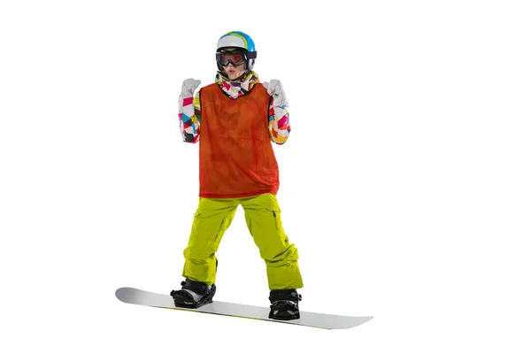 Happy young girl in bright sportswear, goggles and helmet standing with snowboard isolated on white studio background. Concept of winter sports — 图库照片