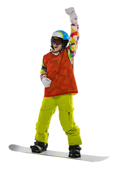 Menina feliz em sportswear brilhante, óculos e capacete de pé com snowboard isolado no fundo do estúdio branco. Conceito de esportes de inverno — Fotografia de Stock