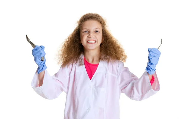 Half-length portrait of cute beautiful little girl, child in image of dentist doctor wearing white lab coat and gloves isolated on white studio background — Fotografia de Stock