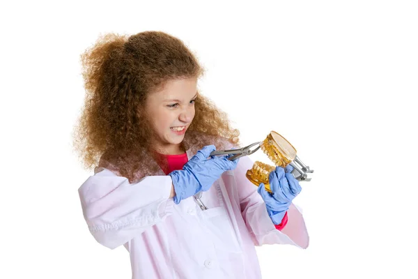 Half-length portrait of cute beautiful little girl, child in image of dentist doctor wearing white lab coat and gloves isolated on white studio background — Stockfoto