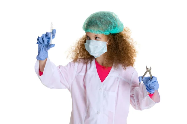 Studio shot of cute little girl, child in image of dentist doctor wearing white lab coat and gloves isolated on white studio background — Stockfoto