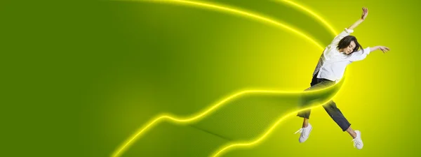 Stylish contemp dancer, beautiful woman dancing isolated on yellow-green color background in neon light with luminescent lines, shapes. — Stockfoto
