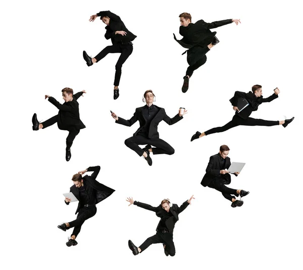 Young man, male office worker wearing black suit jumping, dancing and meditates with folders, coffee, tablet on white background. Ballet dancer. Set — Stock Photo, Image