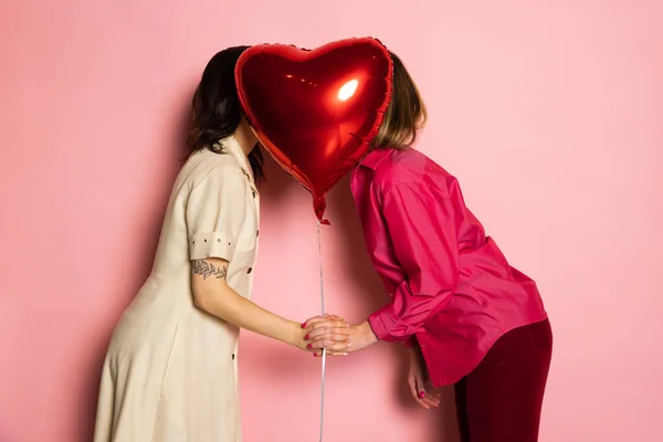 Happy couple holding balloons shaped hearts. Valentines day celebration. Concept of emotions, facial expression, love, relations, romantic holidays. — Stock Photo, Image