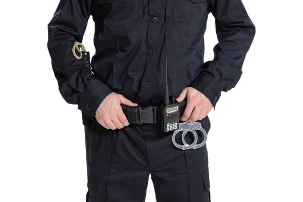 Cropped image of male policeman officer wearing black uniform with walkie-talkie and handcuffs isolated on white background. — Stock Photo, Image