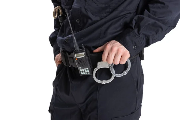 Cropped image of male policeman officer wearing black uniform with walkie-talkie and handcuffs isolated on white background. — Stock Photo, Image