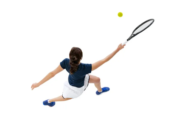 Flygfoto av ung vacker flicka, tennisspelare i sportkläder spelar tennis isolerad på vit bakgrund. Skönhet, sport koncept. — Stockfoto