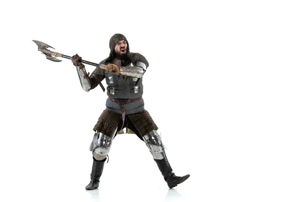 Full-length portrait of brutal serious man, medieval knight swinging ax, ready to figth isolated over white studio background — Stock Photo, Image