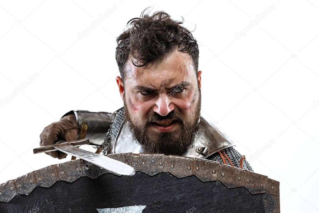 Cropped portrait of brave and brutal medieval warrior or knight isolated over white background