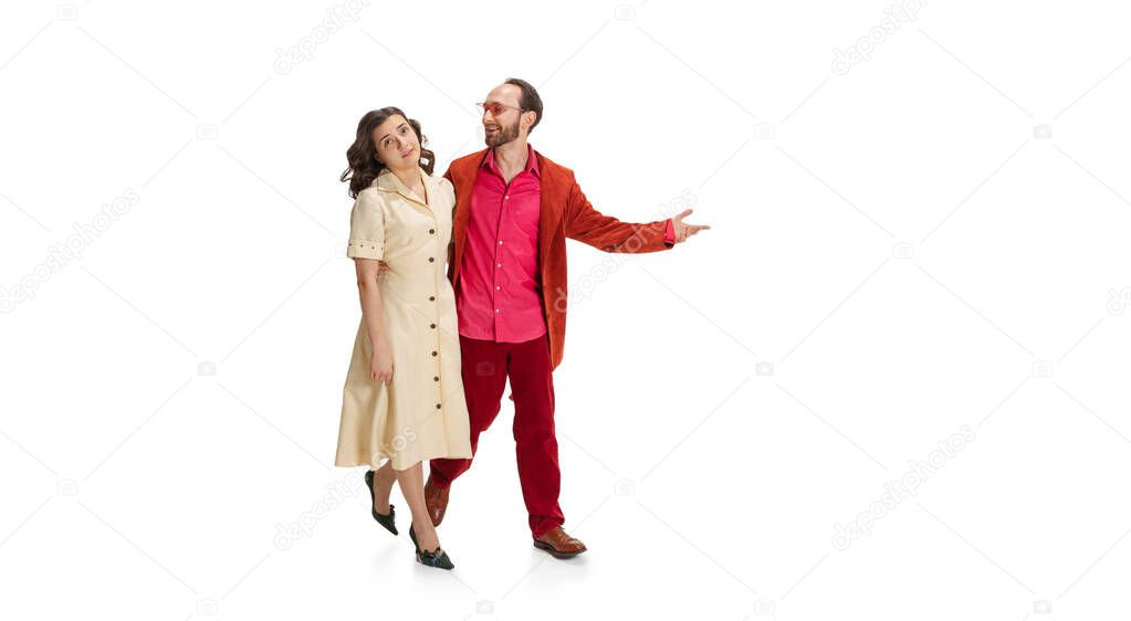 Young married couple, young man and woman in old-school fashioned attire strolling isolated on white background. Vintage, hipster