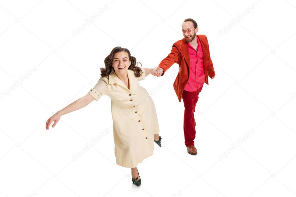Aerial view of happy, smiling man and woman in old-school fashioned attire strolling isolated on white background. Vintage, hipster