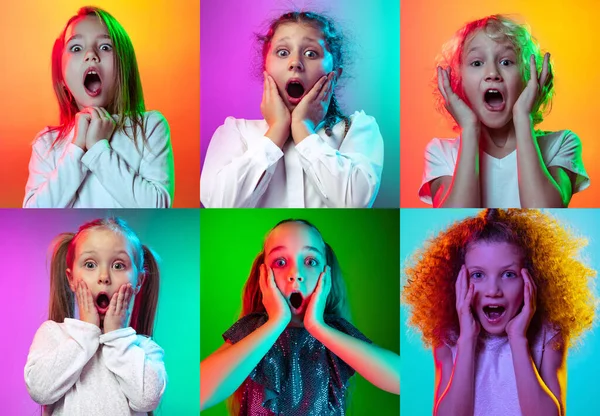 Barnens känslor. Uppsättning porträtt av små söta barn, pojkar och flickor isolerade på flerfärgad studio bakgrund i neonljus. Utbildning, wow känslor — Stockfoto