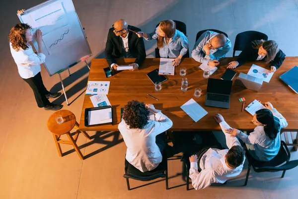 Training new employees. Aerial view of young multiethnic people talking, working with colleagues, co-workers at office, indoors. Work, finance, tech concept. — Stock Photo, Image