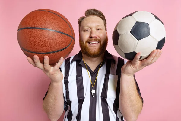 Comic portrait of sport referee wearing field judge uniform isolated on pink studio background. Concept of sport, rules, competitions, rights, ad, sales. — Stock Photo, Image