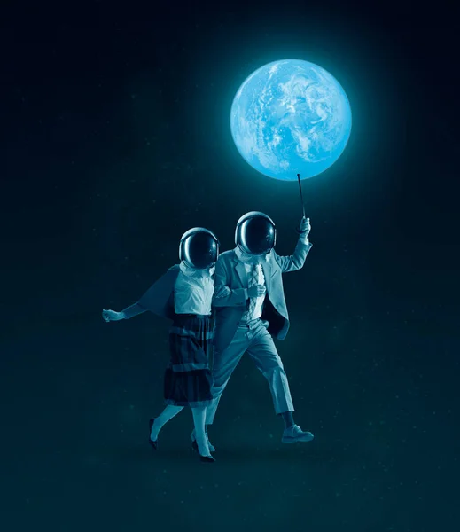 Σύνθεση με άνδρα και γυναίκα που φορούν ρετρό ρούχα και κράνη και περπατούν κάτω από τον έναστρο νυχτερινό ουρανό. Έννοια της αστροναυτικής, όνειρα, Ημέρα της ανθρώπινης διαστημικής πτήσης — Φωτογραφία Αρχείου