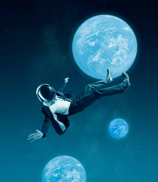 Conceptual creative artwork with businessman in helmet flying at outer space on sky background. Concept of astronautics, dreams, astronomy, art, Day of Human Space Flight — Stock Photo, Image