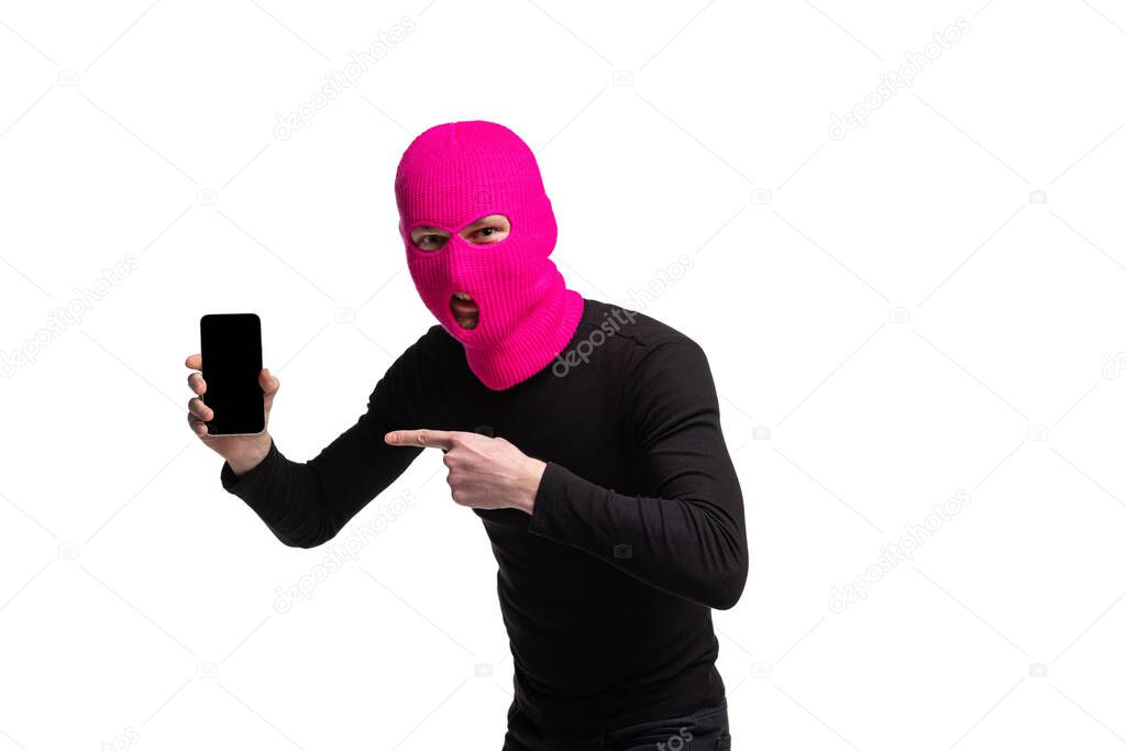 Portrait of young anonymous person wearing black outfit and balaclava isolated on white background. Concept of art, fashion, anti-terrorizm