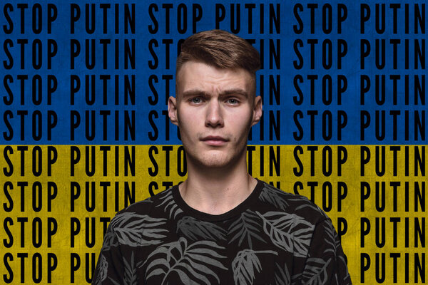 Portrait of young man asking to stop Putin isolated over blue and yellow flag background with lettering