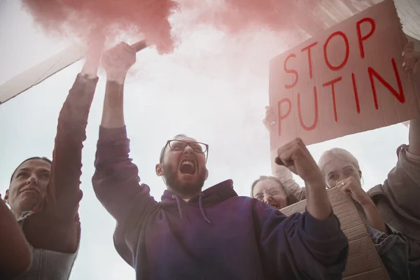 Grupo de jóvenes con carteles en marcha, huelga contra la guerra en Ucrania y la invasión rusa. Concepto de derechos humanos, libertad, paz —  Fotos de Stock