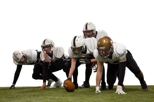 Group of young sportive men, professional american football players in sports uniform and equipment posing isolated on white background. — Stock Photo, Image
