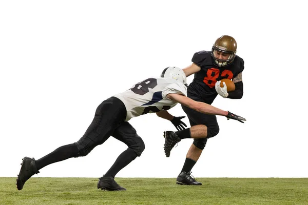 Twee mannelijke amerikaanse voetballers spelen tijdens de sport wedstrijd op gras vloeren geïsoleerd op witte achtergrond. Concept van sport, uitdagingen, doelen, kracht. Affiche, banner voor reclame — Stockfoto