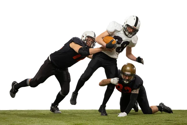Tackling. Three young sportive men, professional american football players in sports uniform and equipment in action isolated on white background. Concept of super bowl — Stock Photo, Image