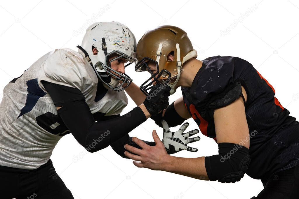 Close-up of two male american football players fighting for ball isolated on white background. Concept of sport, challenges, goals, strength. Poster, banner for ad