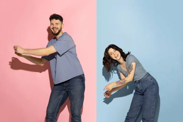 Joven pareja emocionada de divertido y feliz hombre y chica bailando hip-hop, divirtiéndose aislado sobre fondo de color azul y rosa de moda. Concepto de emociones — Foto de Stock