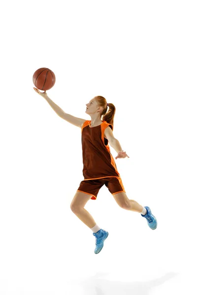 Retrato completo de menina esportiva jovem, jogador de basquete profissional em movimento, formação isolada sobre fundo estúdio branco — Fotografia de Stock