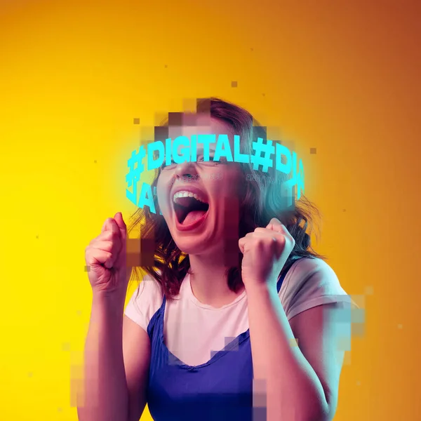 Contemporray artwork. Young emotive girl with neon lettering around pixel head isolated over yellow background in neon light — Stock Photo, Image