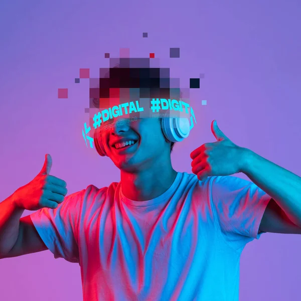 Contemporary art. Young smiling man with pixel head elements listening to music in headphones isolated on purple background in pink neon — Stock Photo, Image