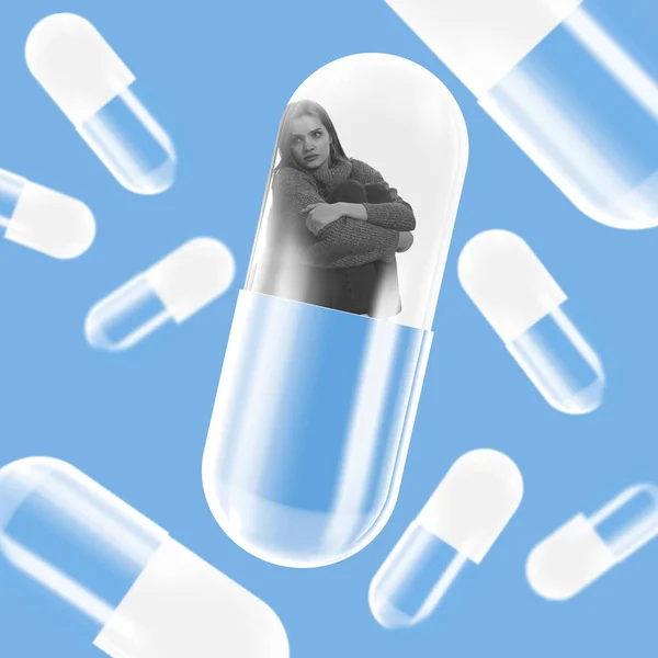Soledad. collage de arte contemporáneo. Joven mujer deprimida sentada dentro de una píldora gigante aislada sobre fondo azul. — Foto de Stock