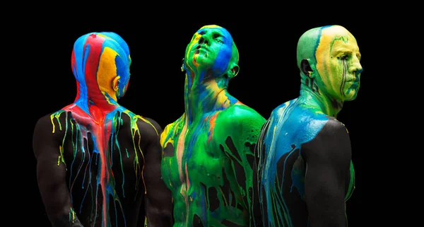 Colagem colorida. Corpo masculino e rosto coberto com tintas multicoloridas isoladas sobre fundo preto — Fotografia de Stock