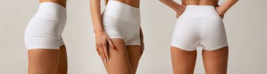 Gri arka planda izole edilmiş pamuk beyaz şortlu spor kadın kalçaları. Anti-selülit bakım konsepti