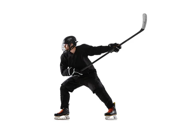 Portrait of man, professional sportsman, hockey player in black protective uniform training isolated over white background — Stok Foto