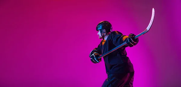 Portret aktywnego człowieka, profesjonalny hokeista w ruchu, trening na różowym tle w neonowym świetle. Ulotka — Zdjęcie stockowe