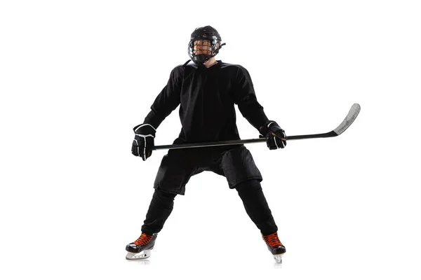 Full-length portrait of professional male hockey player with stick in uniform posing isolated over white background — Stock Photo, Image