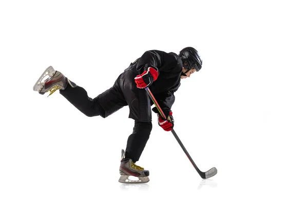 Winning game. Portrait of concentrated boy, child, hockey player in motion, training isolated over white background. — Stock Photo, Image