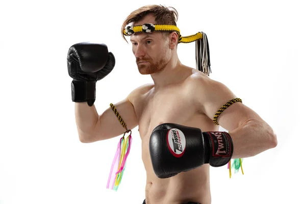 Retrato de medio cuerpo del hombre musculoso, boxeador tailandés en uniforme deportivo posando aislado sobre fondo blanco del estudio. Deporte, muay thai, competición, concepto de club de lucha — Foto de Stock